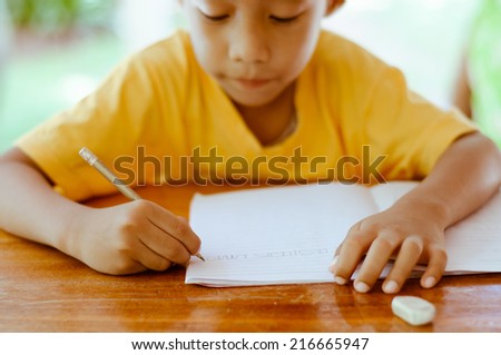Asian Boy Try to Writing The English Alphabets.