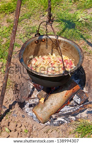 Preparing stew on outdoor fire