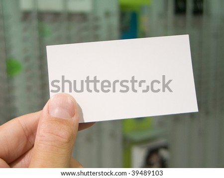 Hand holding blank visit card