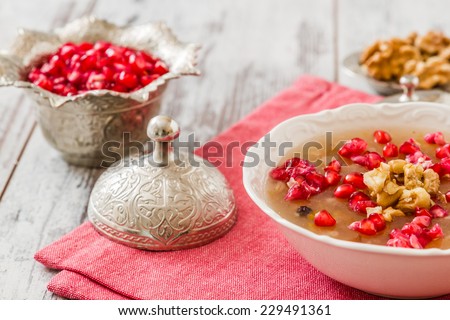 Turkish dessert Ashura, Noah\'s pudding, with pomegranate seeds and walnuts