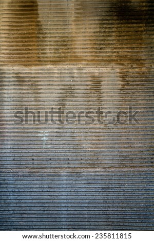 Rusty door texture of an old garage door and wall