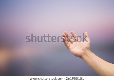 Right hand with empty on blurred twilight backgrounds with selective focus,soft focused