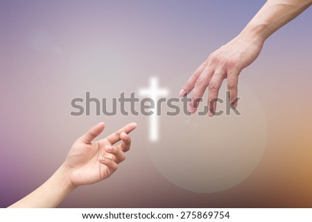 god\'s hands giving white cross for rescue human on blurred sky backgrounds.hands isolated on blurred backgrounds.