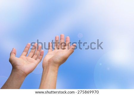 Human's hands pray on blurred nature background , soft focused