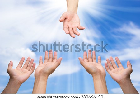 helping hand and hands praying on blurred blue sky background with ray light , helping hand concept
