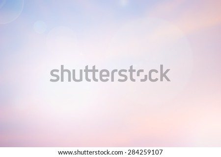 abstract blurred background of sea ocean sunrise sky landscape with shining flare lights.blurry colored of pink/purple/gold wallpaper with sunshine concept.soft shining ray flares beach backdrop.