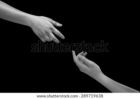 Human\'s hands help together isolated on black backgrounds.helping hand concept,black and white hands concept.
