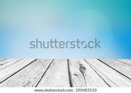 old vintage wooden desk table with blurred sea and blue sky backgrounds , put and show your products on this backgrounds