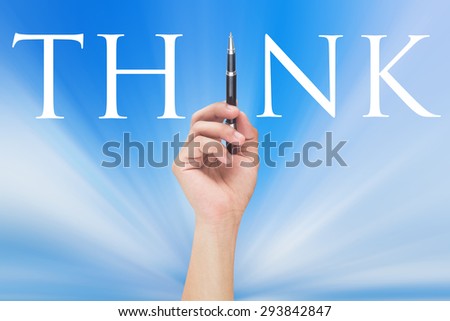 hand writing massage think at transparent board on blurred blue sky background