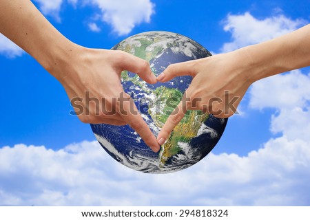 close up male and female hands making heart shape over the world.safe the world concept.love the world concept.Elements of this image furnished by NASA