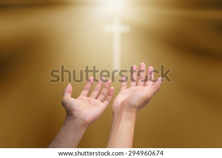 human\'s hands praying cross on blurred twilight sky background : hand open receiving power from god. religion concept.