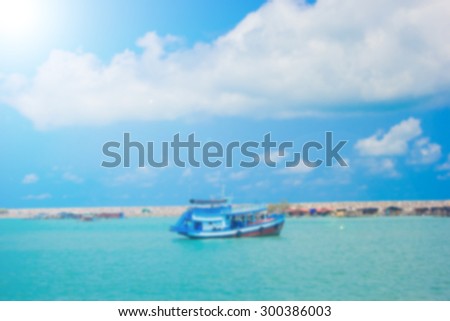 blurred natural of sea with blue sky and boat backgrounds.blurred summer season styles concept.blue and green colors styles.