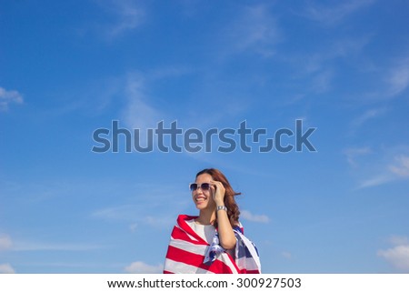 close up beautiful woman looking forward over blurred blue sky backgrounds(blank on blue sky for your text).for work about  advertisement,business,web,design,decorate,education and etc.