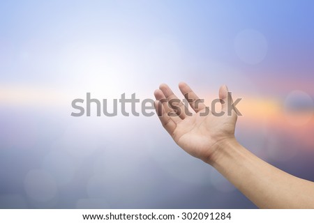 Human hands open palm gesture on blurred sea background: hand receiving power form god.religious concept.