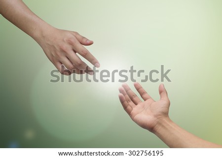 helping hand and hands praying on blurred nature background , helping hand concept.hand of power concept.