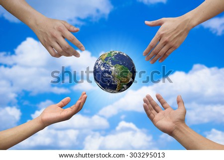 Four hands reaching the world for heal together, save the world concept ,Elements of this image furnished by NASA.