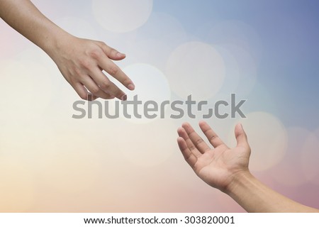 helping hand and hands praying on blurred beautiful twilight sky backgrounds with circle light. helping hand concept.hand of god giving the power to human's hand.
