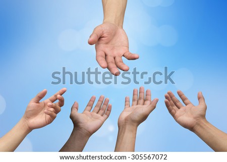 helping hand and hands praying on blurred blue color  background with circle light , helping hand concept.