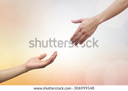 helping hand and hands praying over blurred beautiful backgrounds. helping hand concept.hand of god giving the power to human\'s hand