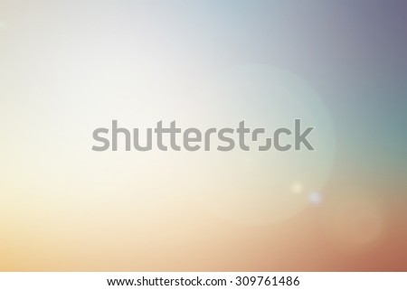 blur nature sea with flare light background.blurred tropical summer backdrop concept.warm tone light of hope from paradise conceptual.pastel colorful tone wallpaper with sun ray.abstract picture ideal