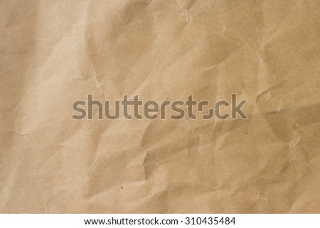 crumpled tan warm tone color paper texture for backgrounds in vintage:detail of crinkle,wrinkle of plain texture:crush brown parchment backdrop:jagged beige of recycle carton wallpaper:handmade wall.