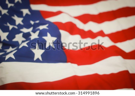 abstract vintage blurred crumpled retro american flag with vignette backgrounds : blur crumpled and creased fabric textures of American flag with vignette backgrounds.image