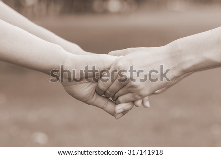 close up and selective focused of women hands holding together for helping and cheer up : helping hands concept :family and friends concept.image in sepia tone color styles.happy family.