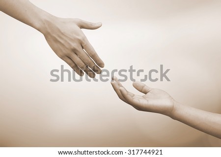 helping hand and hands praying.forgiveness conceptual.god giving the power to human.abstract support/cheerful concept in sepia vintage tone color:spiritual of faith:together/love/heal/care conception.