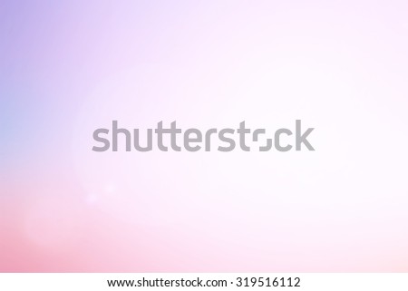 blurred colorful of twilight sky backgrounds with shiny flare light : blurry of purple,pink,yellow color pattern with shiny light:blur natural backgrounds concept:blur of sweet color background.