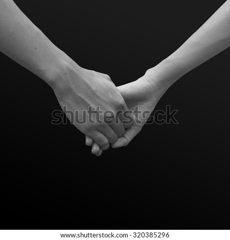 close up of human hands holding together for helping and cheer up : helping hands concept :family and friends concept.hand of power family.abstract helping hand in black and white tone colors concept.