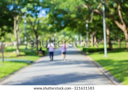 blurred backgrounds of people exercise at parks outdoor:blur of people running,walking,jogging at park:blur of nature park outdoor:blur and out of focus concept:blurred of sport and activity concept.