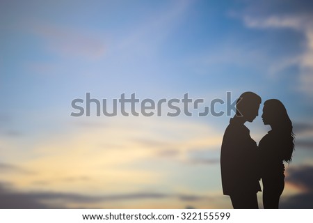 silhouette lover couple over sunset backgrounds at the beach :black shadow loving people hug and try to kiss for show about their love each other : passion in love concept.decorate,design,valentines