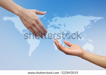 helping hand and hands praying over blur map of the world on blurred blue sky backgrounds. helping hand concept.international assistance concept.business concept.peaceful concept.