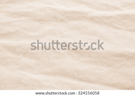 Abstract crumpled orange colored fabric texture backgrounds : creased burlap fabric textures in bright beige sepia color tone.
