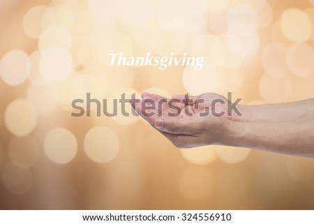humans man hands open gesture for pray over blurred golden bokeh circles light backgrounds with message 'Thanksgiving':humans receiving power or bless from god:religious concept.holidays concept.