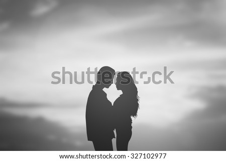 silhouette lover couple over natural backgrounds at the beach :black shadow loving people hug and try to kiss for show about their love each other : passion in love concept.valentines concept.
