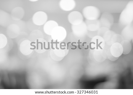 abstract blurred of bokeh light in black and white backgrounds:blurry circle shiny light in gray scale tone colour.image display for design,decorate or etc.