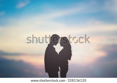 silhouette lover couple over natural backgrounds at the beach :black shadow loving people hug and try to kiss for show about their love each other : passion in love concept.valentines concept.