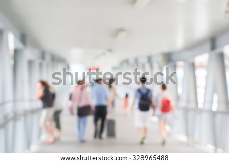abstract blurred of movement crowd people walking to the airport gate for travel or business:blur of indoor architecture concept:blurry people walking crowded conception.traveler concept.
