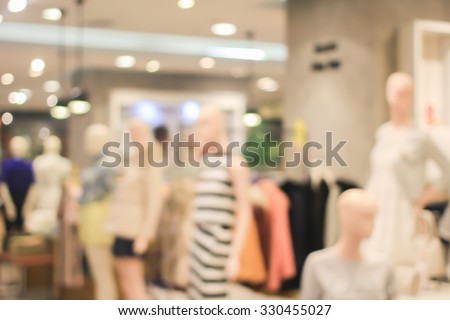 Blurred of people walking in shopping mall at women fashion zone:blur of department store indoors with bokeh lights:lifestyle concept:blurred of shopping mall.blurry mannequins fashion model.