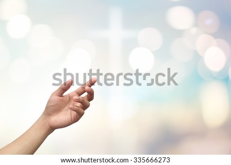 left hands of man  praying on blurred bright color pastel background with bokeh christmas lights:hand palm up open receiving power from god.religion abstract concept.faith and strength conceptual.
