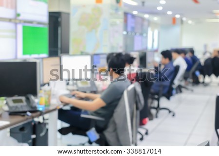 blurred employees operator working on the program computer at the office room:blur group of people monitoring alarm on computer programing concept:blurred of education,business and technology concept.