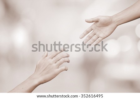 helping hand and hands praying.supporting of humanity conceptual.giving power concept:friends and family relationship,encouragement:abstract healing and assistance hands in vintage tone color concept.