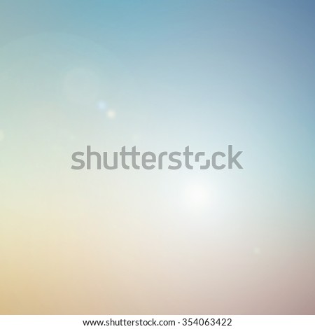 blurred background of sea with lens flare lights.blurry nature backdrop concept.summer warm blur wallpaper concept.pastel canopy heaven color tone.sundown/sunset time hour. square wallpaper conception