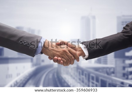 close up business man handshake together on cityscape background:agreement ,accept,approve finance cooperative.improve development of world international network.trust goal team hand shake:loyalty law