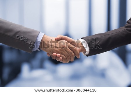 close up business man handshake together on blur meeting room background in :agreement,accept,approve financial cooperative concept.improve/development.trust,goal,team,hand,shake:international  invest