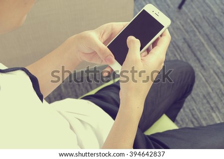 close up man\'s hand holding mobile phone device:focus on boy work/play/read/call/text/type on smart phone concept:human people and innovation technology conception.addiction of smartphone symptoms.
