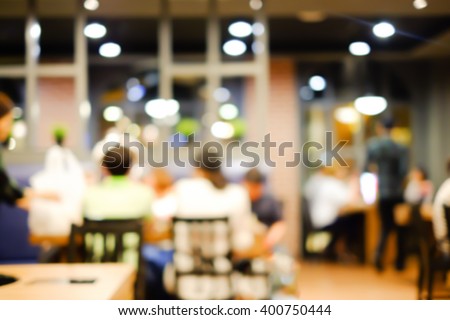 abstract blurred group of asian family meeting in the restaurant background:blurry of caucasian people having funny party after working concept:blur lifestyle manner conceptual.
