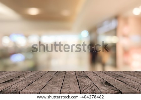 old vintage grungy brown wood tabletop with blurred supermarket store light color background:grunge aged wooden with blurry warm cream light bokeh backdrop.show/promote/advertise product on display