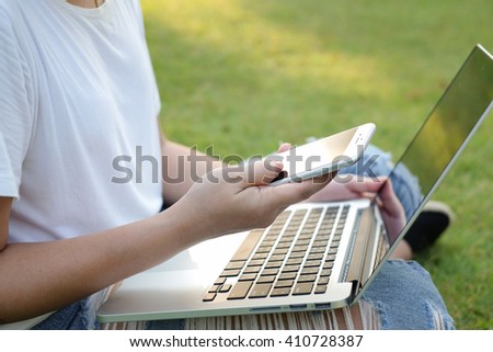 close up girl teenager playing smartphone device within doing homework at laptop notebook:woman with addiction of innovation technology symptom:education technology and healthcare concept:social media